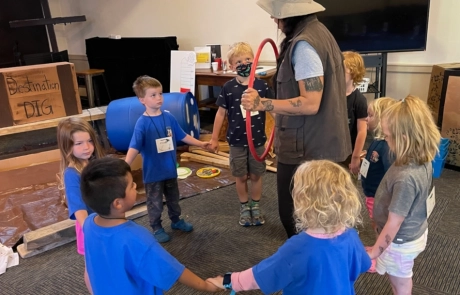 Children's Ministry - Kids Holding Hands in Circle Around Teacher